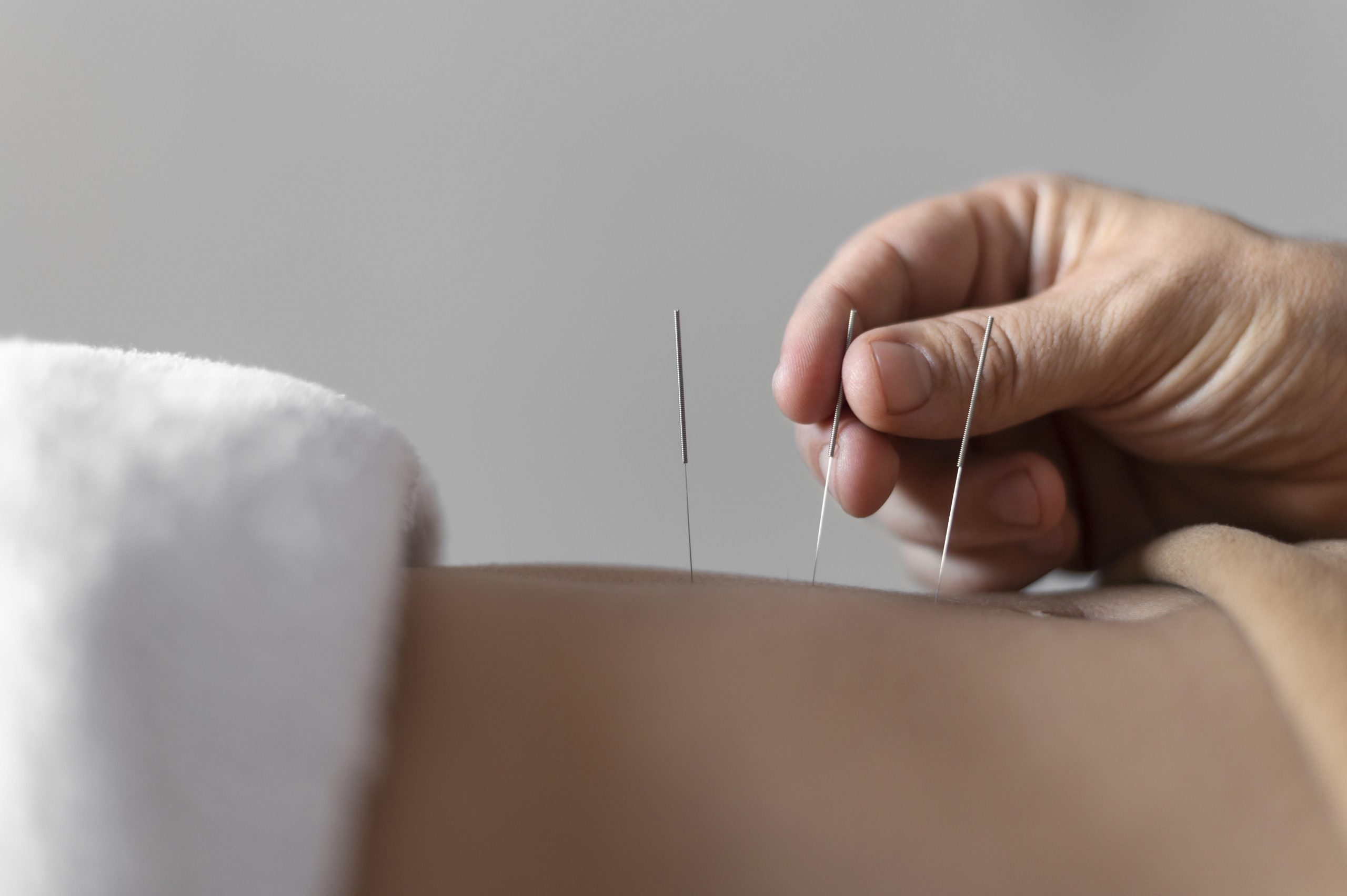 https://www.hijamahouse.com/wp-content/uploads/2023/01/close-up-hand-holding-acupuncture-needle-scaled.jpg